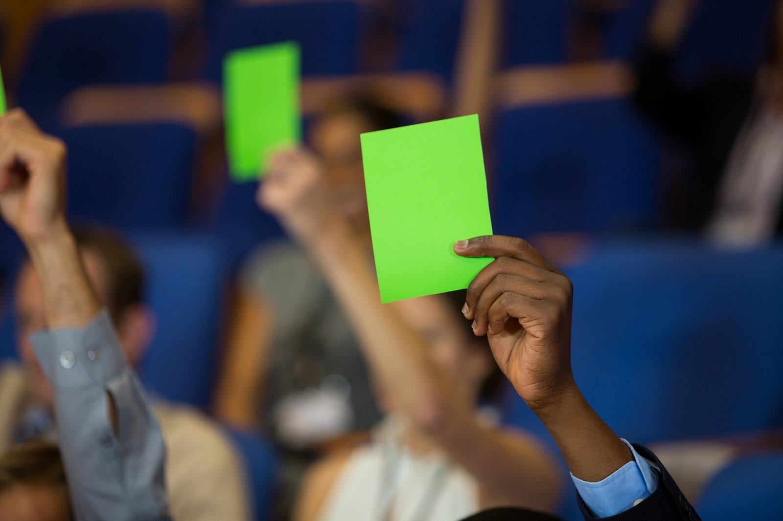 Business executives show their approval by raising hands